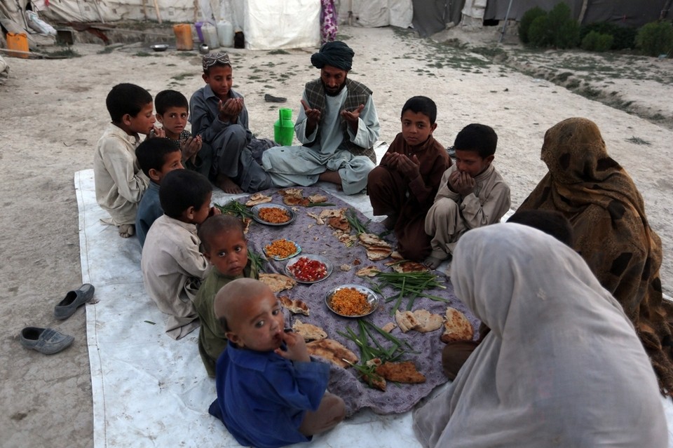 An internally displaced Afghan family breaks their fast during the holy month of Ramadan in Kabul, Afghanistan, on June 20, 2015. Devout Muslims throughout the world are marking the month of Ramadan, the holiest month in the Is
