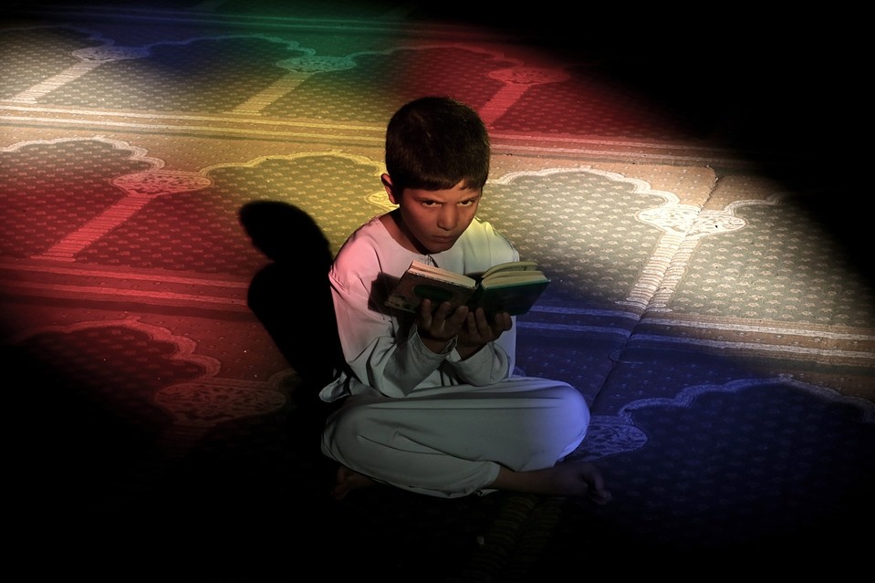 A Palestinian boy reads the Quran in the Al-Omari mosque during the Muslim holy month of Ramadan, in Gaza City, June 20, 2015. Most Muslims around the world have begun observing the holy fasting month of Ramadan. 